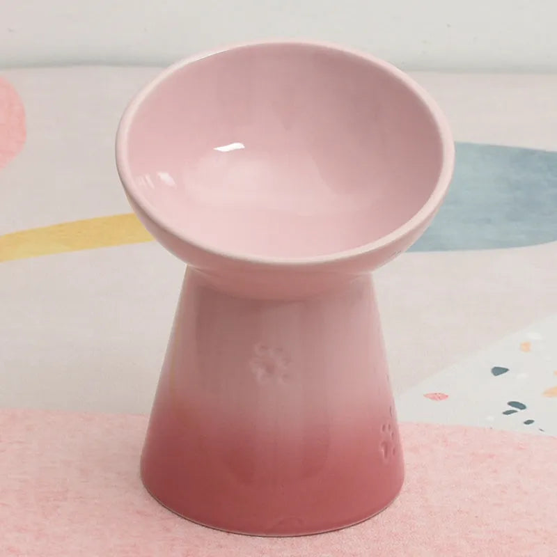 White high-foot ceramic pet bowl with slanted rim on a non-slip base for dogs and cats.