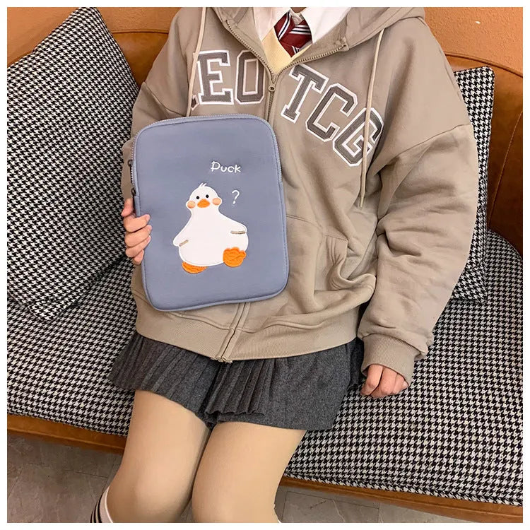 Blue tablet case with embroidered cartoon duck design and a silver zipper closure.