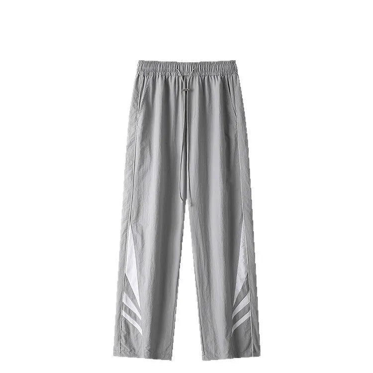 Men's straight-leg casual trousers in black, showing loose fit and button fly detail.