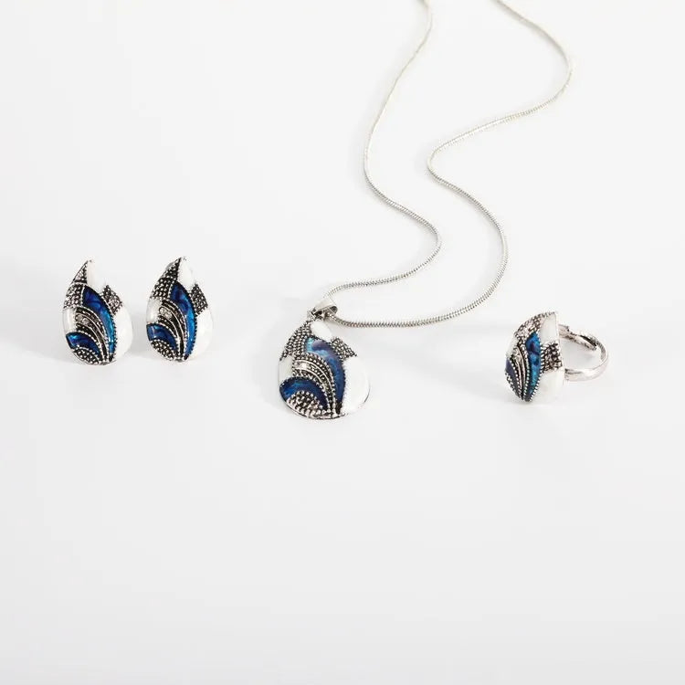 Gold water drop jewellery set with necklace, earrings, and ring on white background