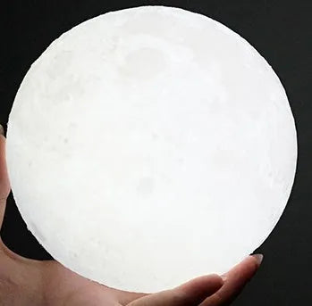 3D printed white moon lamp with detailed craters on a wooden holder, showing touch ring at base.
