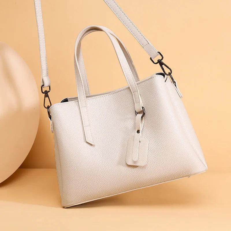 Genuine cowhide leather women's large capacity shoulder handbag in horizontal square shape with organiser pockets.