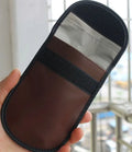 Black plain microfiber faraday cage bag for blocking RFID and phone signals, shown with a key fob inside.