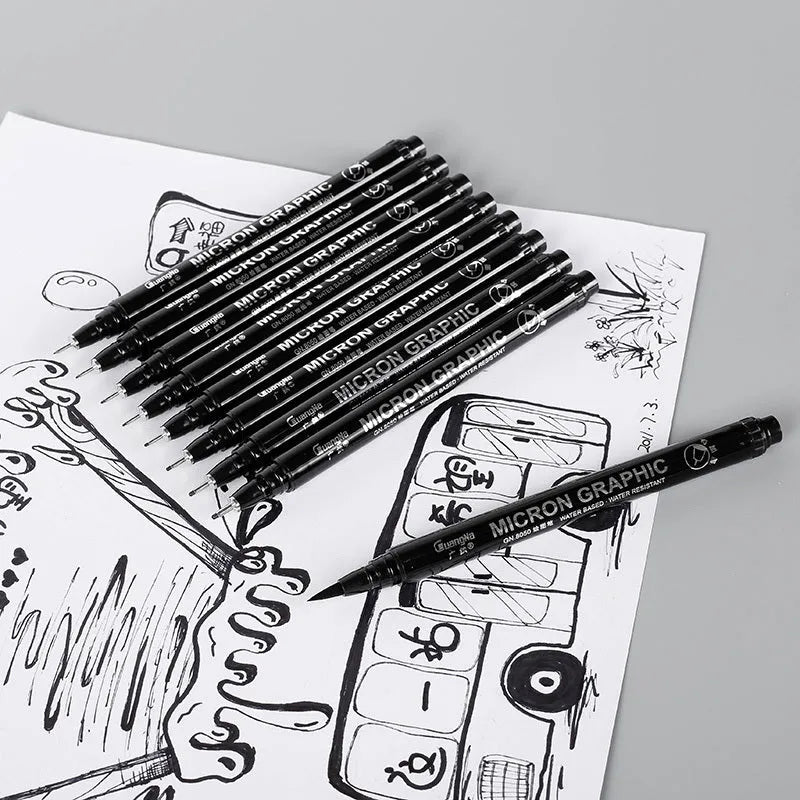 Set of black comic drawing pens with multiple nib sizes in a storage bag organiser.