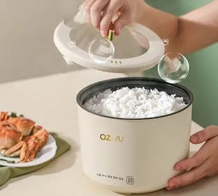Small round automatic rice cooker with non-stick pot and steam pan for one or two people.