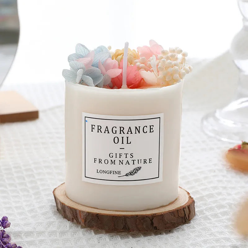 Decorative aromatherapy candle with dried flowers on a wood chip base, available in multiple scents.