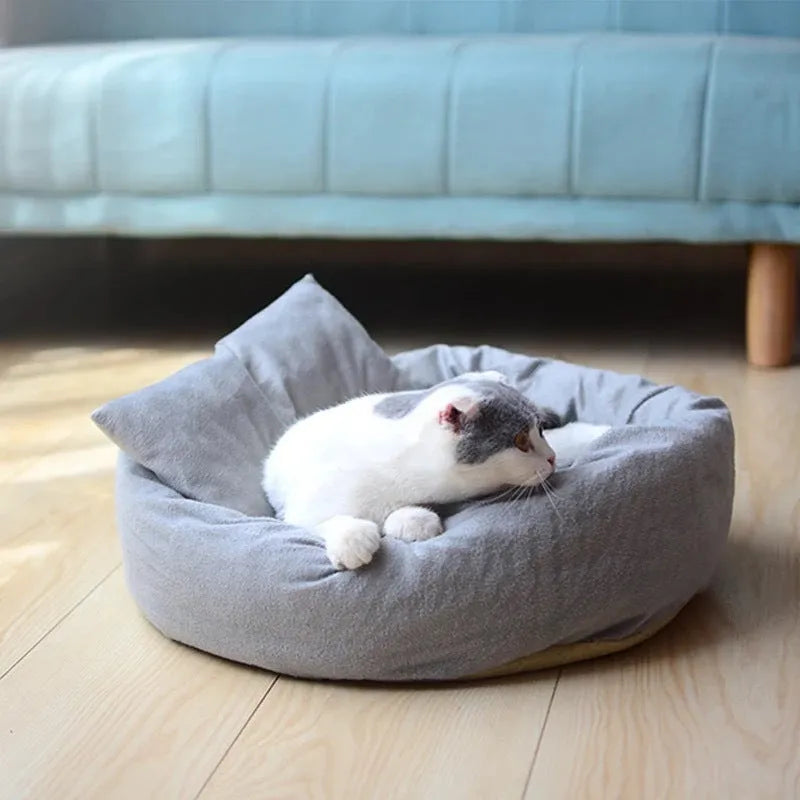 Grey round plush pet bed with raised rim and removable pillow for small dogs and cats.