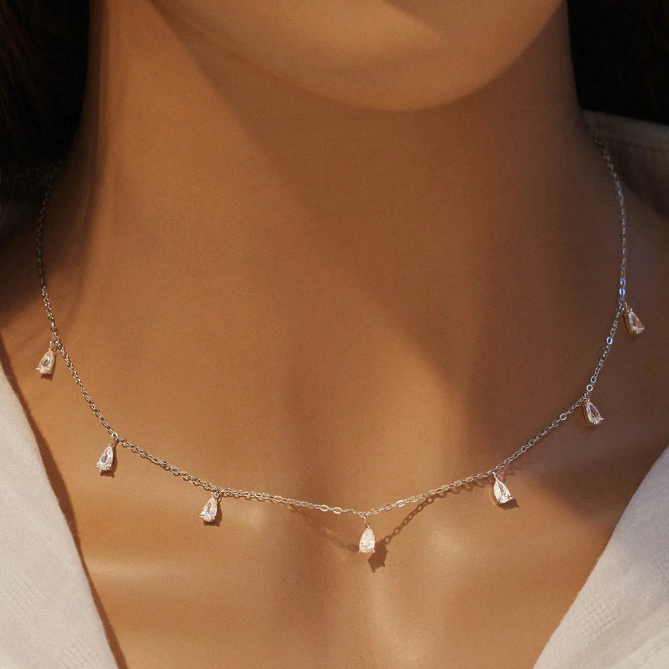 Women's silver drop-shaped artificial zircon necklace on an O-shaped chain, shown in rose gold, golden yellow and silver finishes.