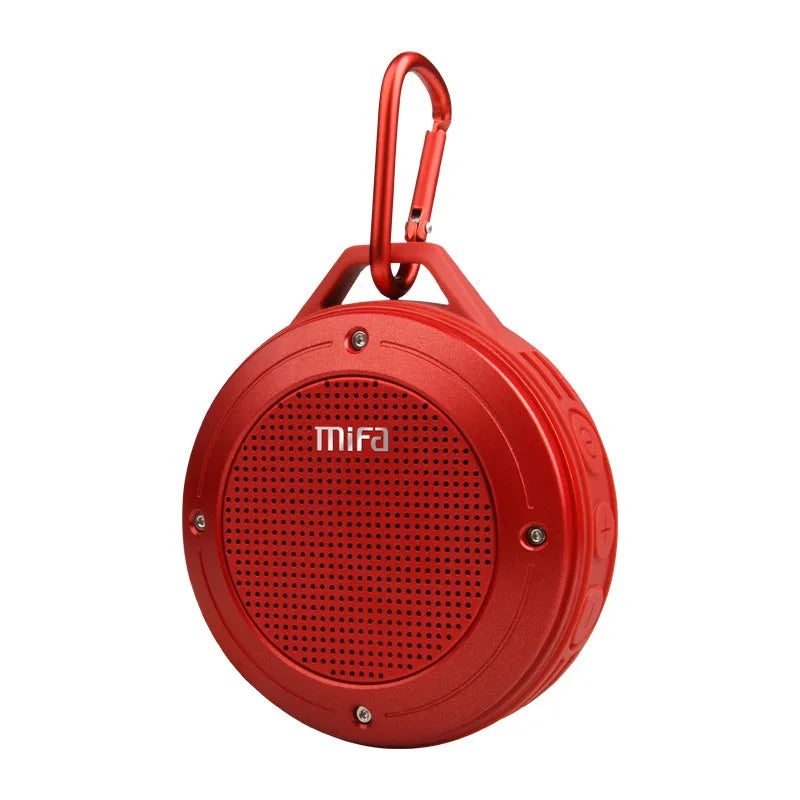 Portable Bluetooth speaker in grey silicone case with button controls, USB port, and compact size