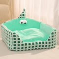 Green triangular pet bed with thick sponge and a removable cover for cats.