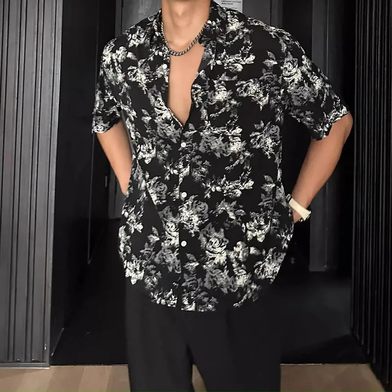 Man's loose black short sleeve shirt with a white floral print pattern.