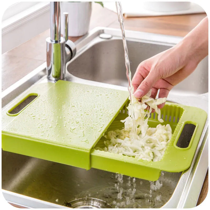 Blue multifunction kitchen chopping board with integrated plastic sink drain basket for vegetable preparation