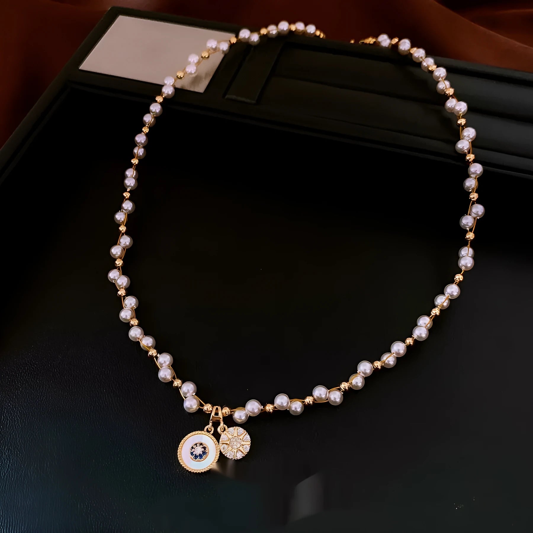 Gold electroplated round pendant necklace with zircon accents on clavicle chain