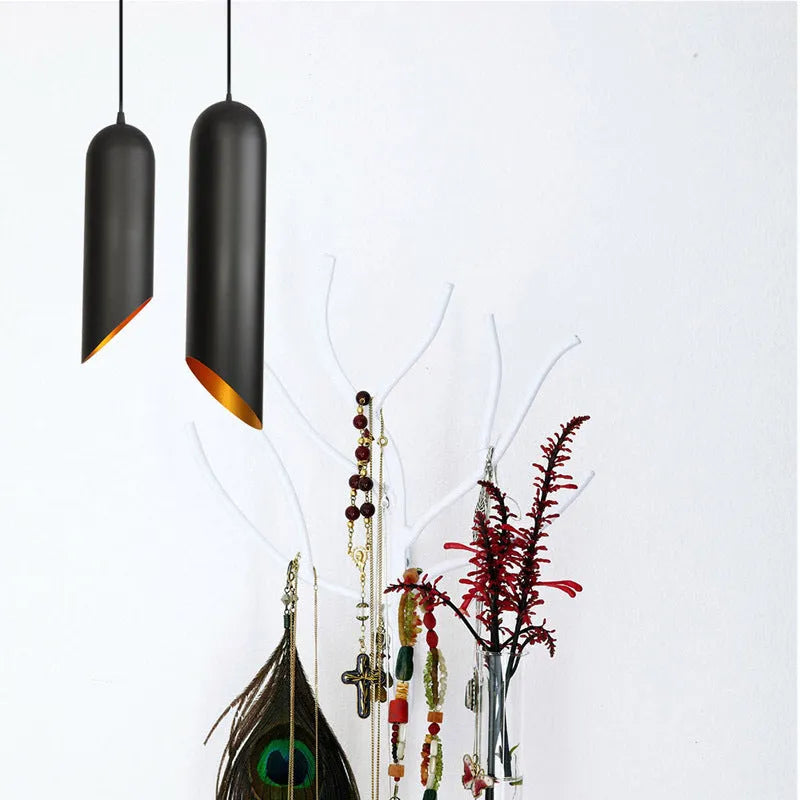 Retro black iron chandelier with multiple light arms hanging from a ceiling