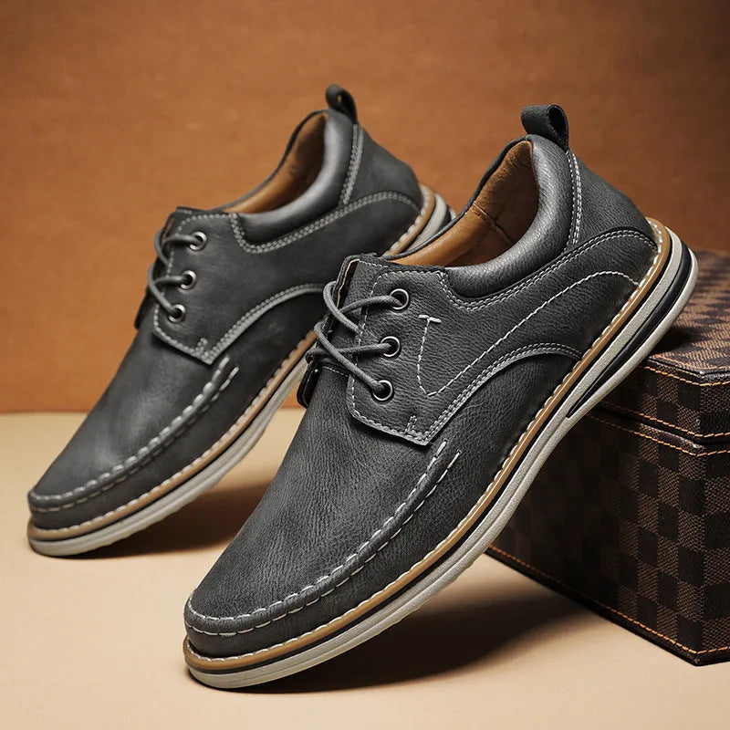 Men's black genuine leather lace-up casual shoes with round toe and rubber sole on a white background