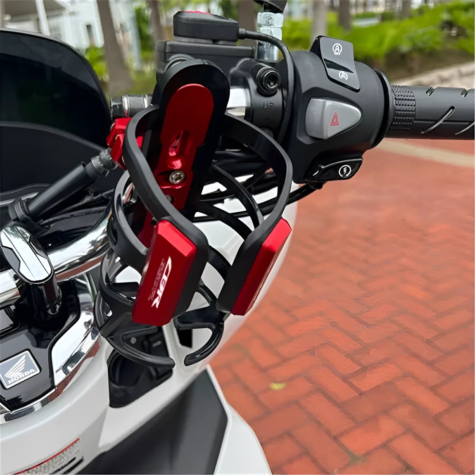 Modified black water bottle cage mounted on a Honda X-ADV scooter frame.