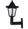 Black hexagonal solar-powered wall lamp for outdoor garden use.