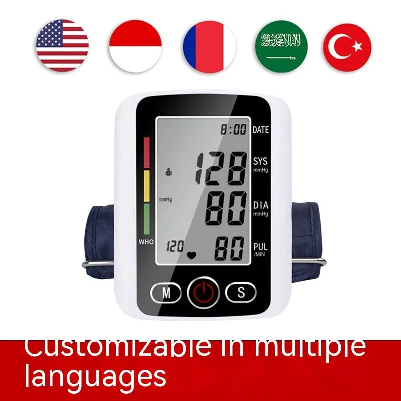 Automatic arm blood pressure monitor on a table with large screen and arm cuff.