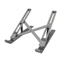 Silver aluminium laptop stand open at an angle next to a closed laptop.