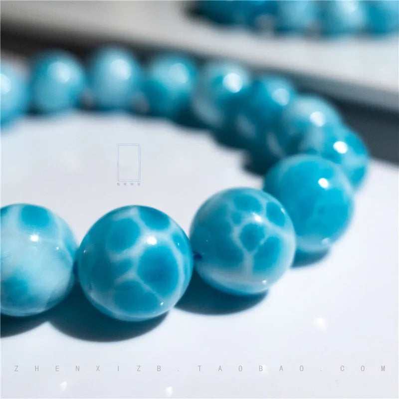 Blue handcrafted Bodhi bracelet with pearl accents, showing different bead size options.