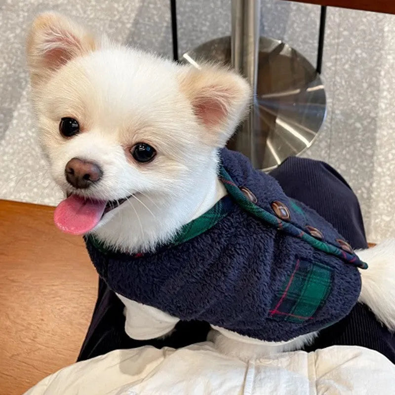 Navy blue pet fleece jacket with checkered pattern, Sherpa lining, decorative buttons, and snowman accent on a small dog