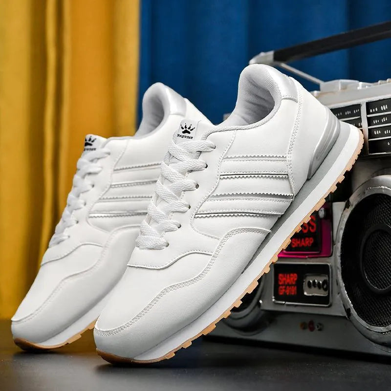 Men's black leather casual sports shoes with carved wing pattern detail and a high heel.