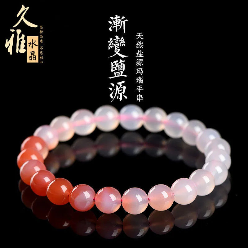 Yanyuan agate bracelet with gradient salt source coloured beads in a geometric shape on a wrist.