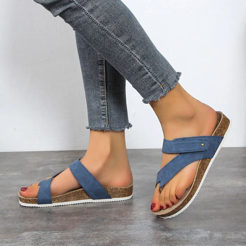 Flat thong sandals with a toe ring and thick foam sole in a solid colour.