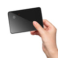 Black rectangular pet tracker card with hanging hole, showing NFC and wireless charging features