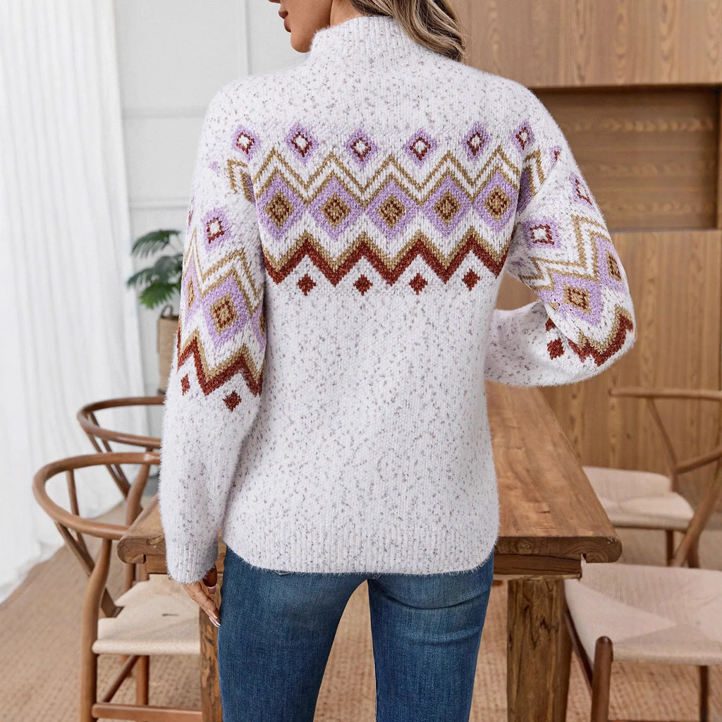 White women's sweater with black geometric jacquard pattern, half turtleneck, and loose long sleeves.