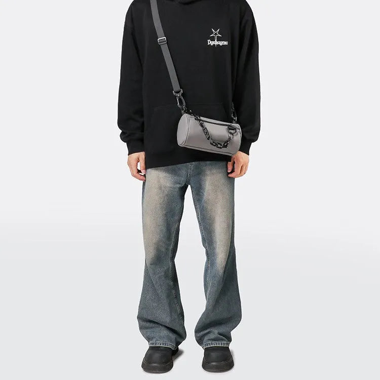 Black casual messenger bag with chain detail and crossbody strap made from Oxford cloth.