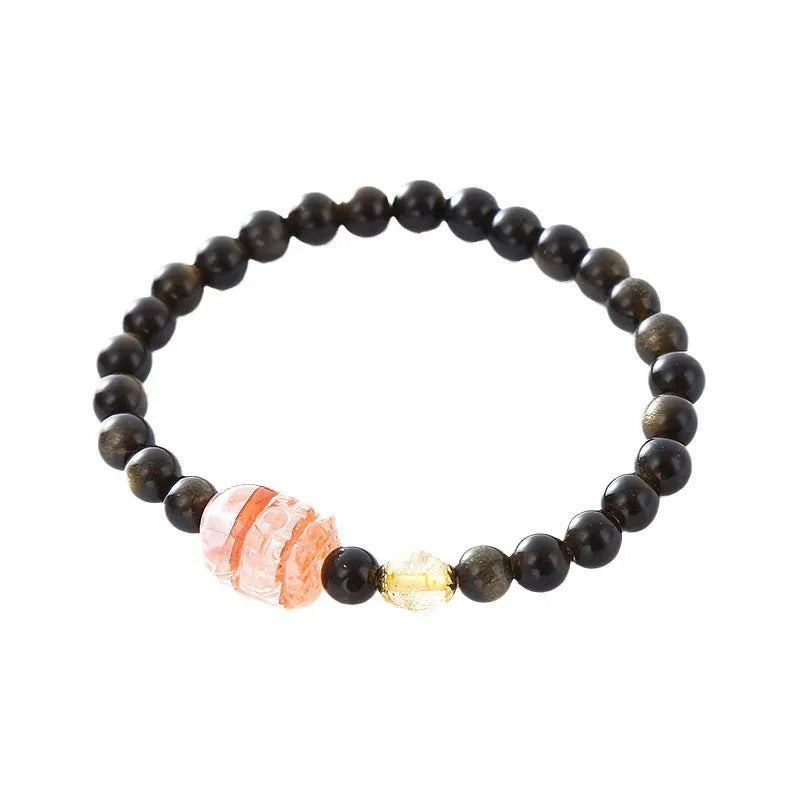 Handcrafted natural obsidian Pi Xiu bracelet with gold and red design on wrist