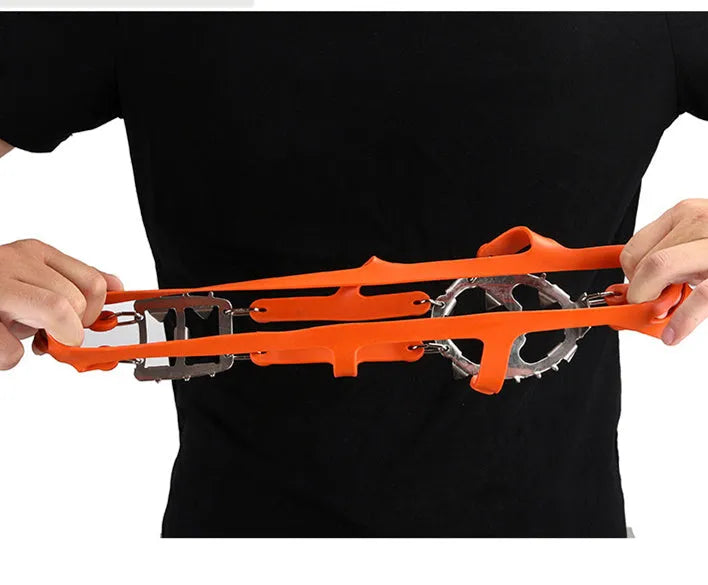 Reinforced non-slip crampons for shoes in black colour with large teeth, shown on a snowy surface