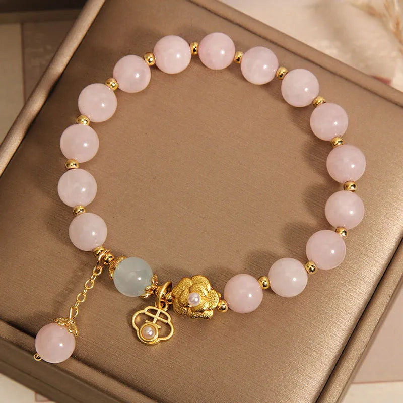 Women's pink crystal flower bracelet with a refined grace design on a wrist.