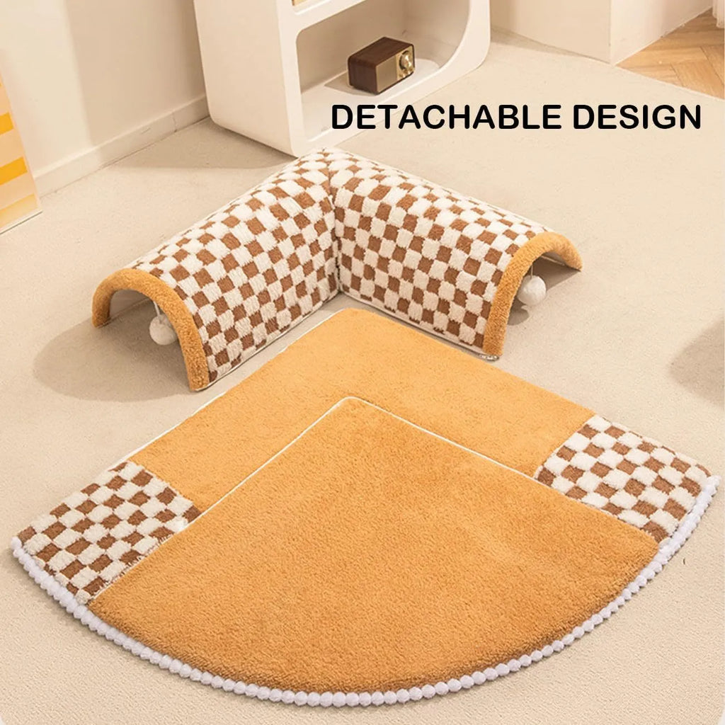 XL fan-shaped plush pet bed with a tunnel, in a plaid coffee colour, on a wooden floor.