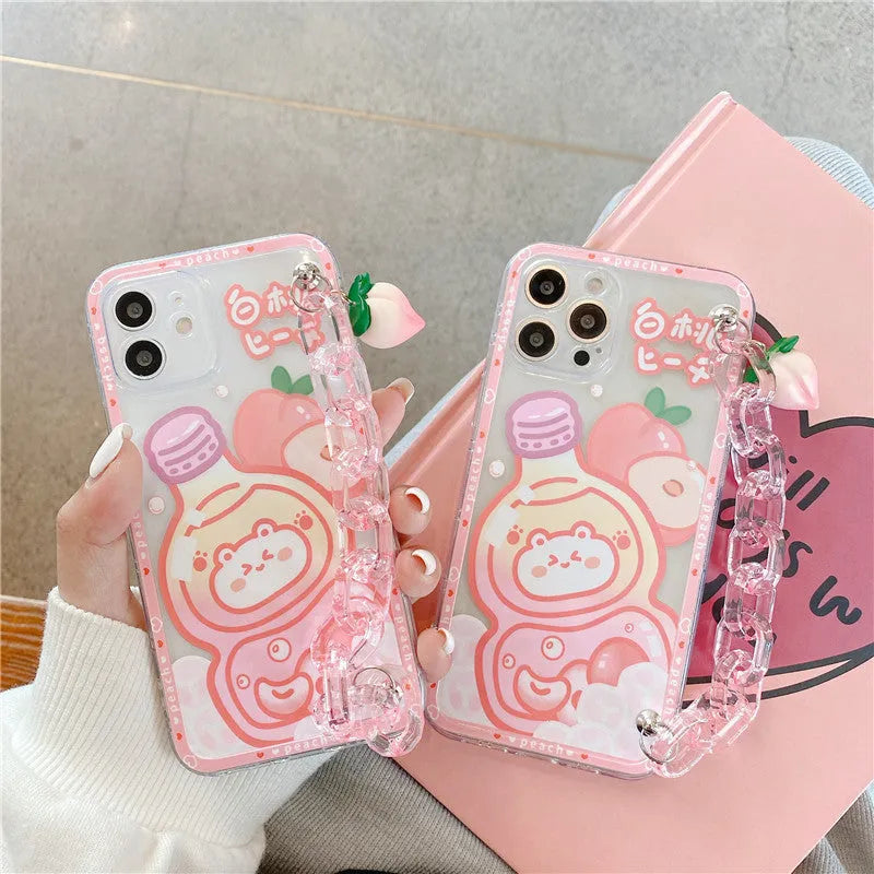 White silicone iPhone case with cartoon peach juice drink and bear design, shown with attached wrist strap.