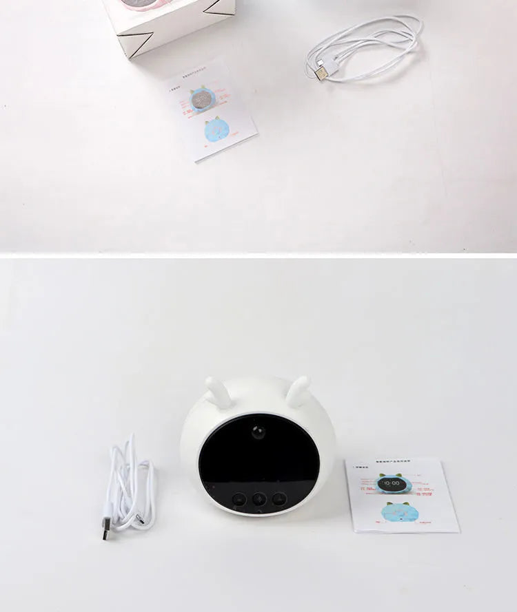 Smart alarm clock with silicone shell, luminous display, featuring voice and motion sensor controls.