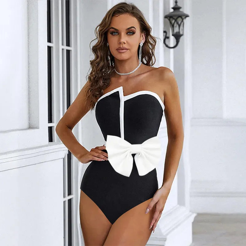 Women's black and white colour-blocking swimsuit with asymmetrical bow detail and tube top design
