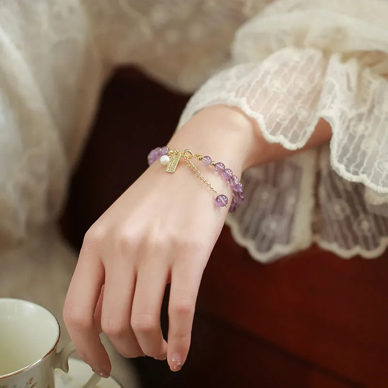 Women's lavender amethyst crystal bracelet with zodiac motif in dark and light colour options