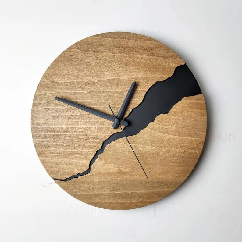 Modern wooden wall clock with creative crack design on a white wall.