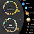 Two natural stone beaded bracelets showing a zodiac symbol design on a flat surface.