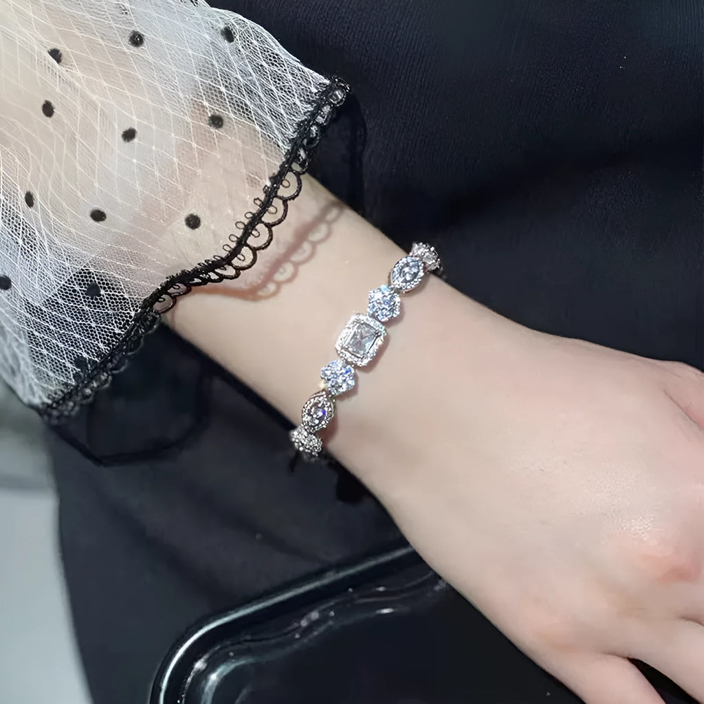 Women's geometric silver bracelet with adjustable chain and sparkling zircon stone on a wrist.
