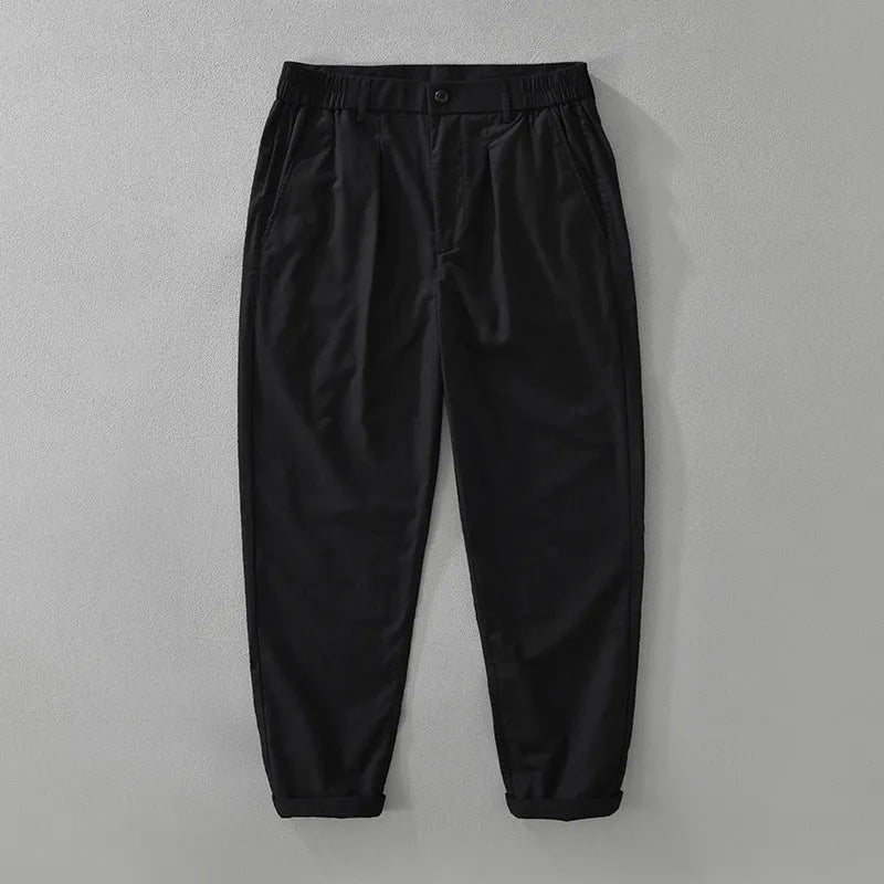 Man wearing loose straight-leg trousers in a cotton linen blend, showing the retro Japanese style in a brown colour.