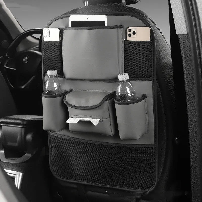 Black PU leather car seat back storage bag hanging on a grey car seat headrest.