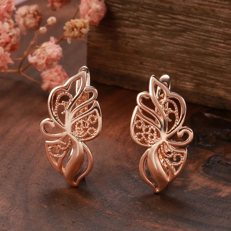 Rose gold geometric earrings for women with hollow carved copper design and rhinestone accents, one pair
