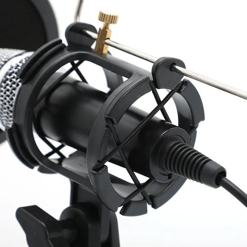 Black condenser microphone on aluminium stand with 3.5mm and USB cables for mobile and computer broadcasting