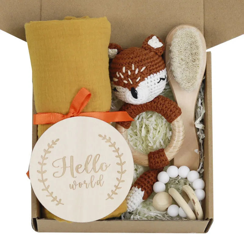 Baby teething gift set with bamboo gauze blanket, wooden chewing ring, woven bell, and developmental toys