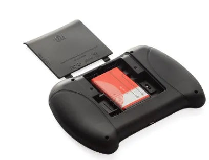 Black wireless QWERTY keyboard air mouse combo with touchpad, 146.8x97.5x19mm, on a table