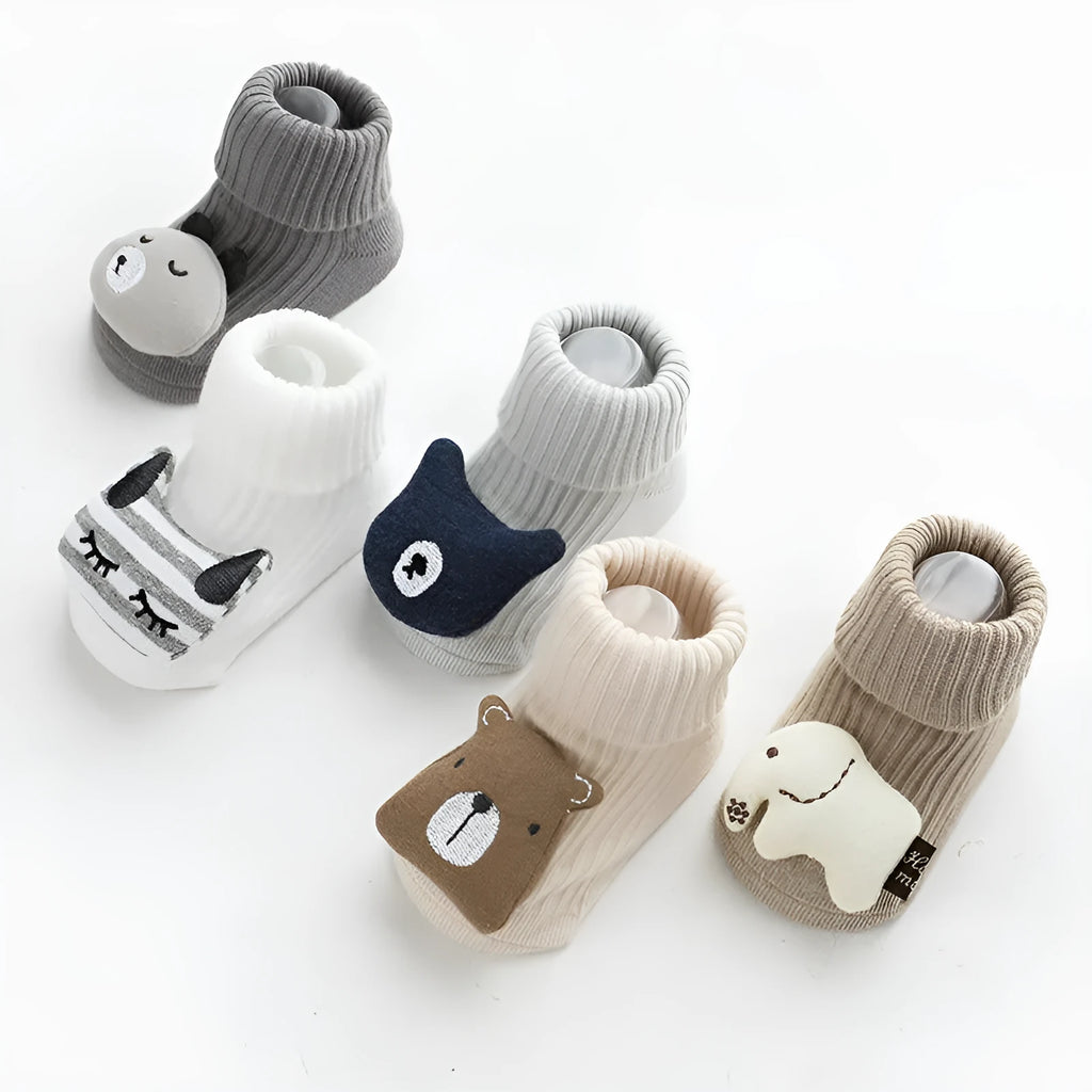 Pair of light grey baby socks with white non-slip silicone grip dots on the soles.