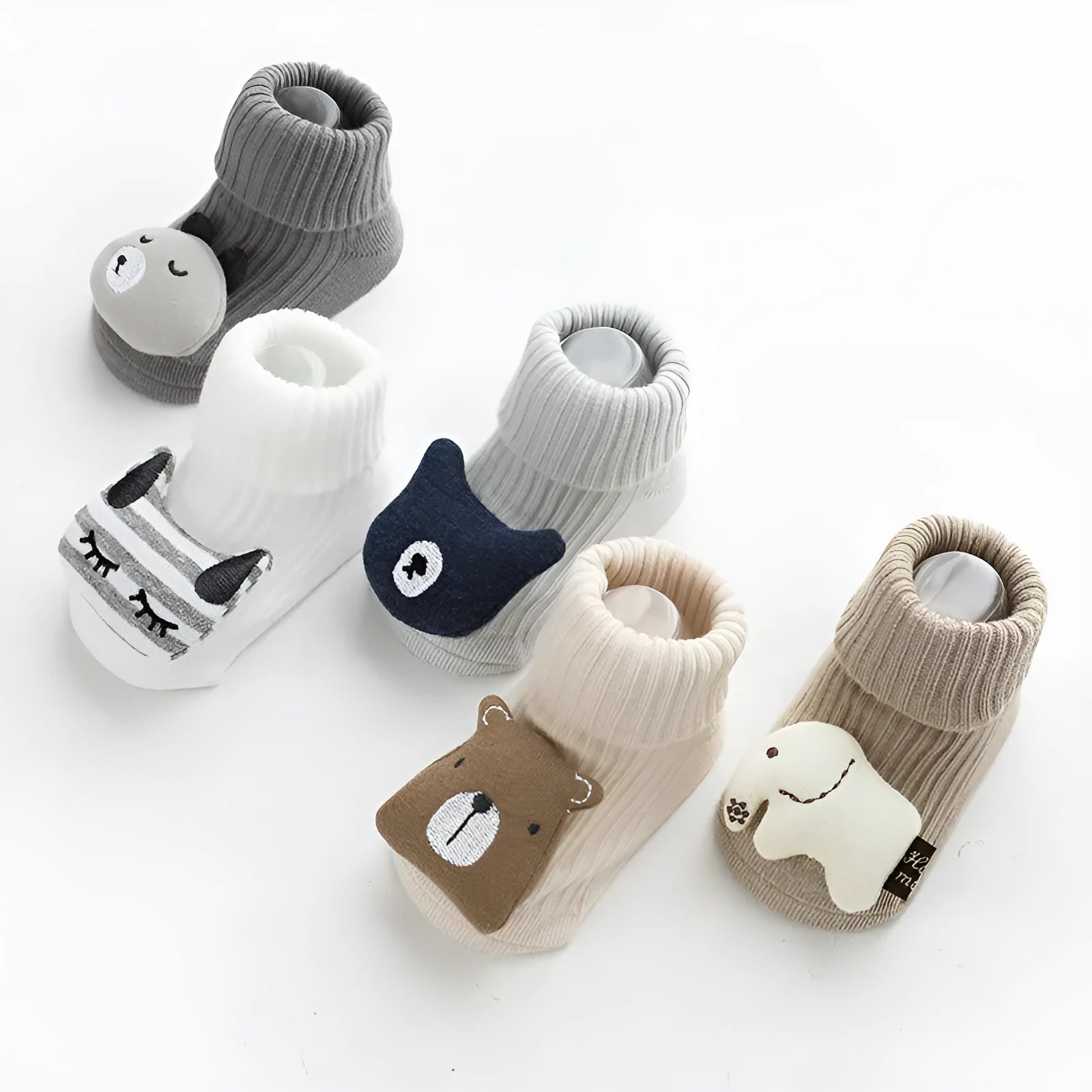 Pair of light grey baby socks with white non-slip silicone grip dots on the soles.
